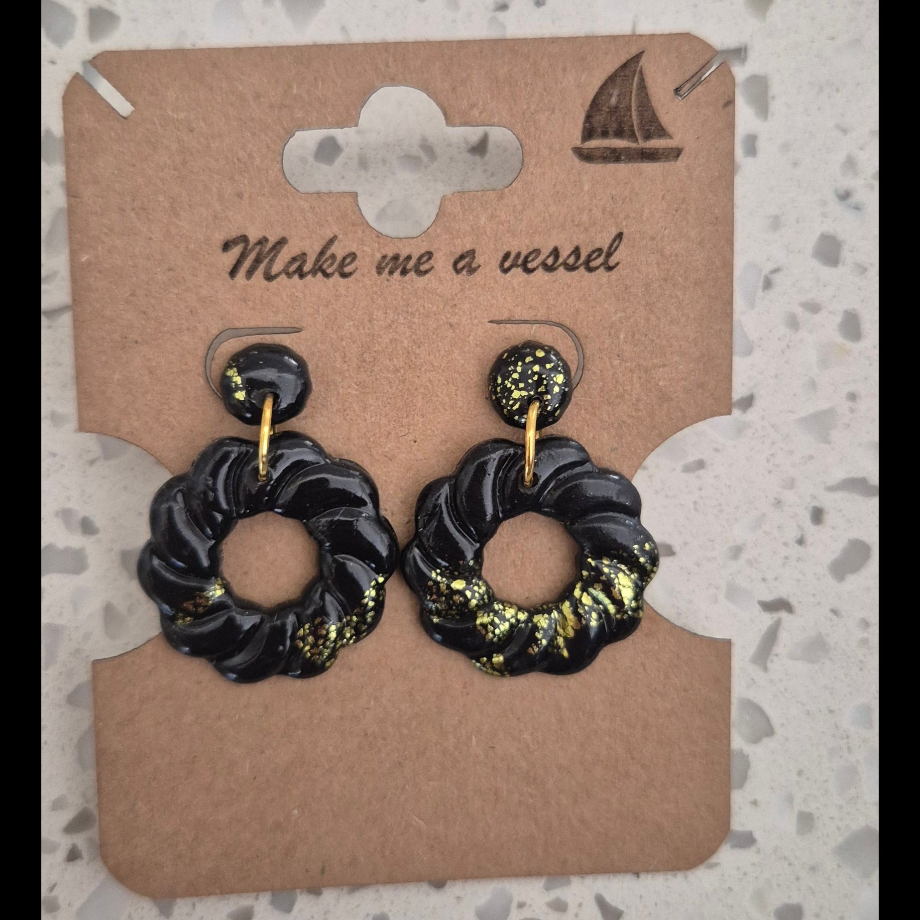 Black and gold circle earrings with gold finishing