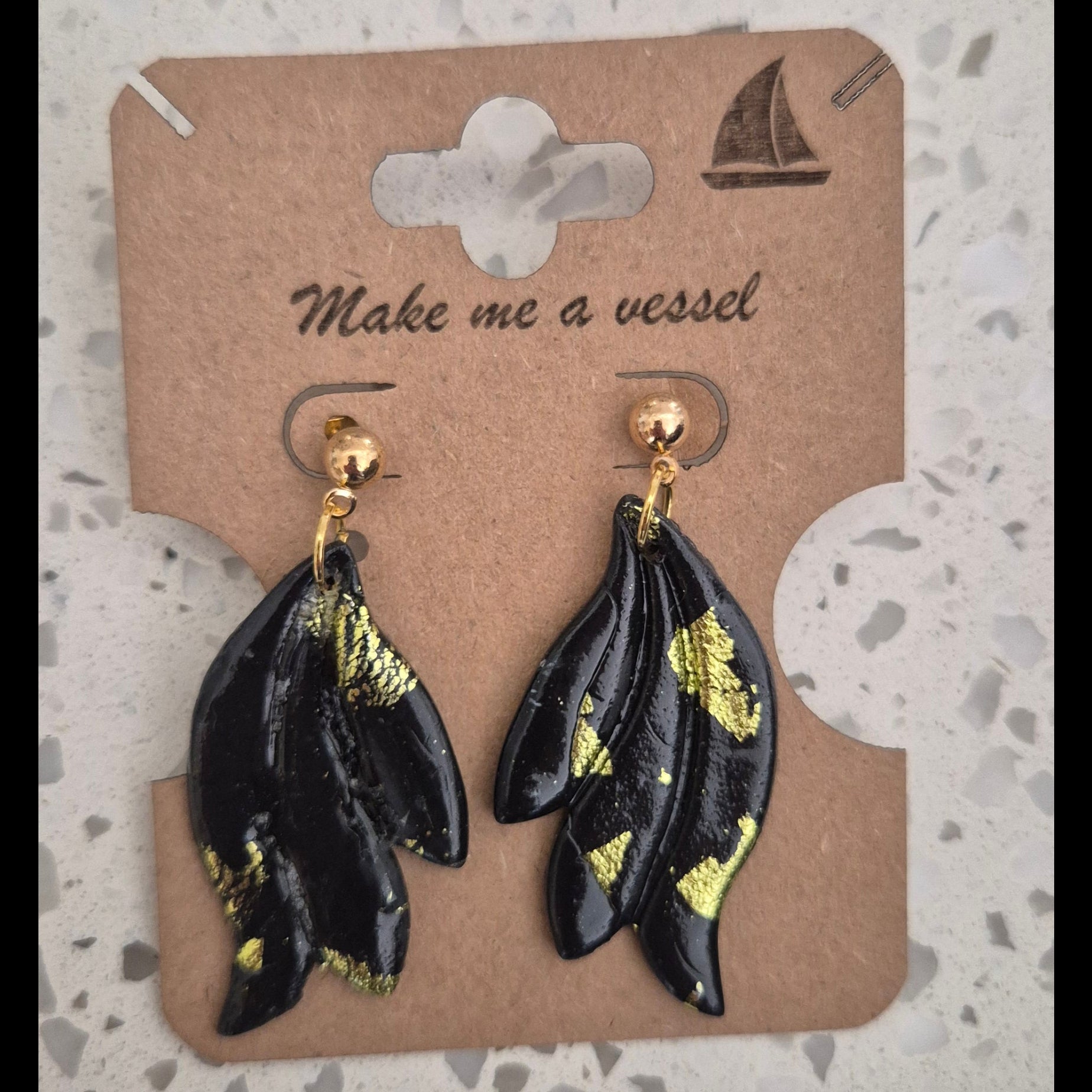 Black and gold feather earrings with gold finishing