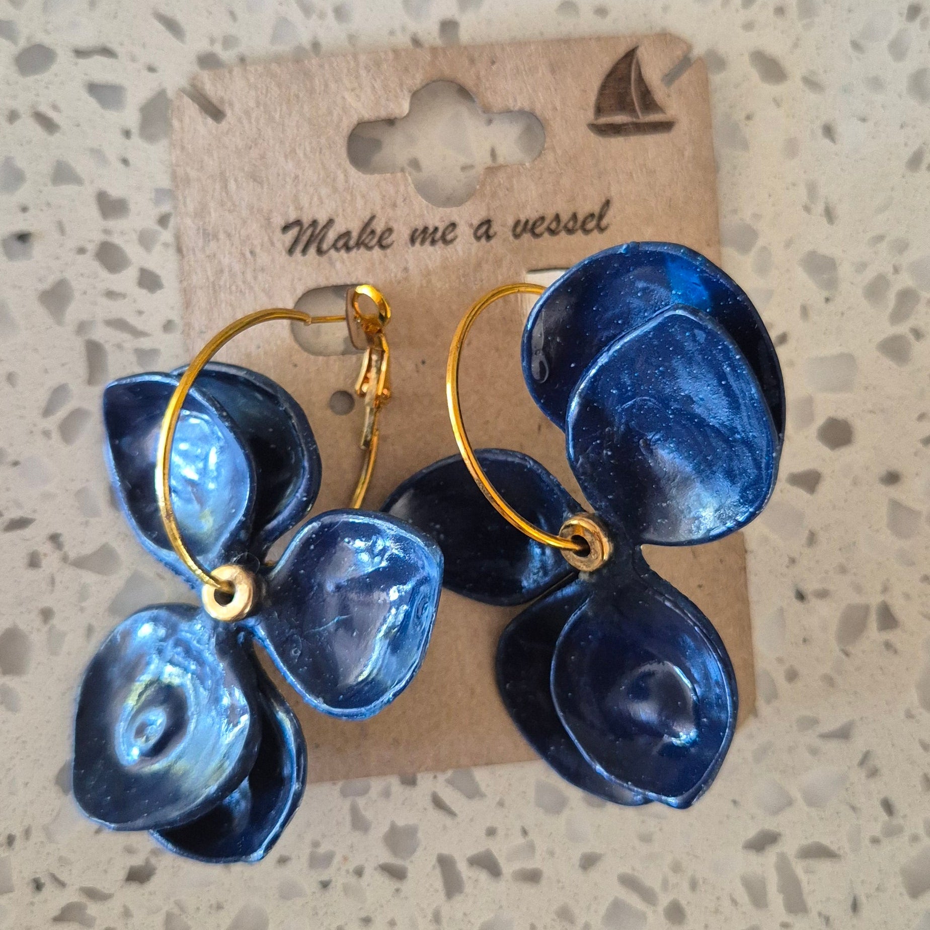 Deep blue twisting flowers with gold hoops